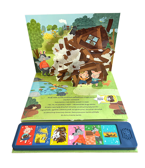 Wnętrze książki z panelem dźwiękowym Słucham Baśni. Trzy świnki przedstawiające wilka który zdmuchnął drewniany dom oraz dwie świnki
